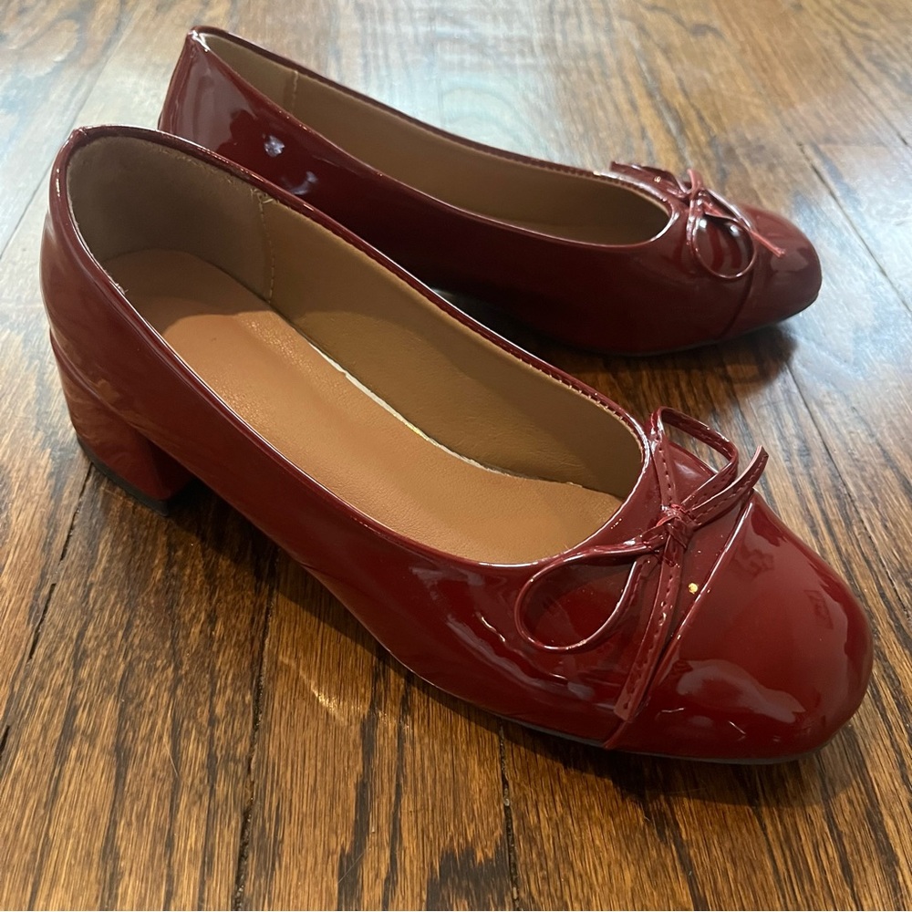 Burgundy patent leather ballet flats with bow detail and short heel
